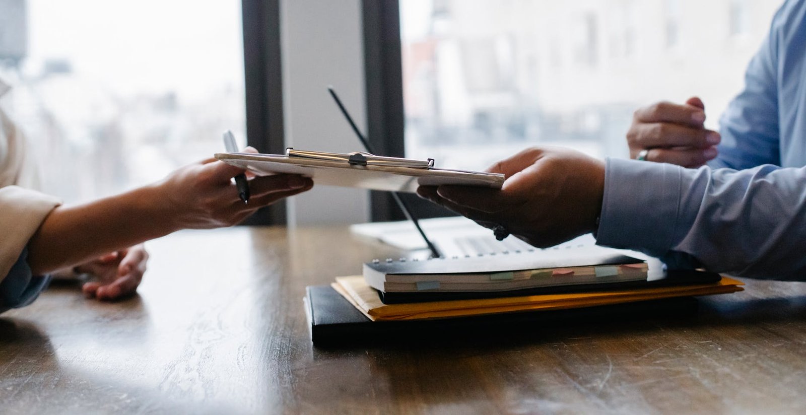 crop black job candidate passing resume to hr employee